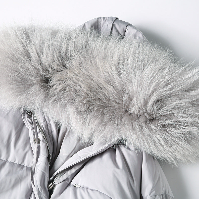 Raccoon-fur hood close-up on gray long puffer coat
