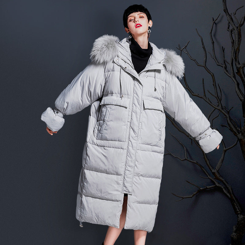 Gray womens long puffer coat with raccoon fur hood, front view