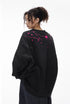 Woman back view black "NO More Ideas" oversized graphic long sleeve tee