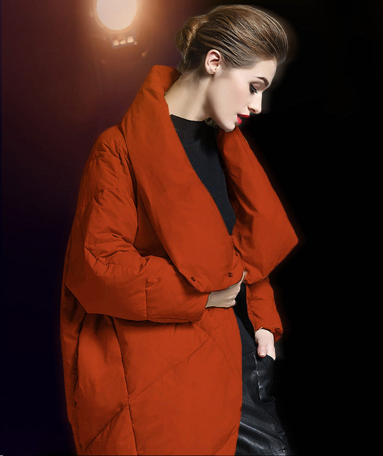 Rust red women’s puffer coat with funnel collar and oversized fit