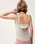 Back view of light gray open-back tank top revealing a white strappy sports bra.