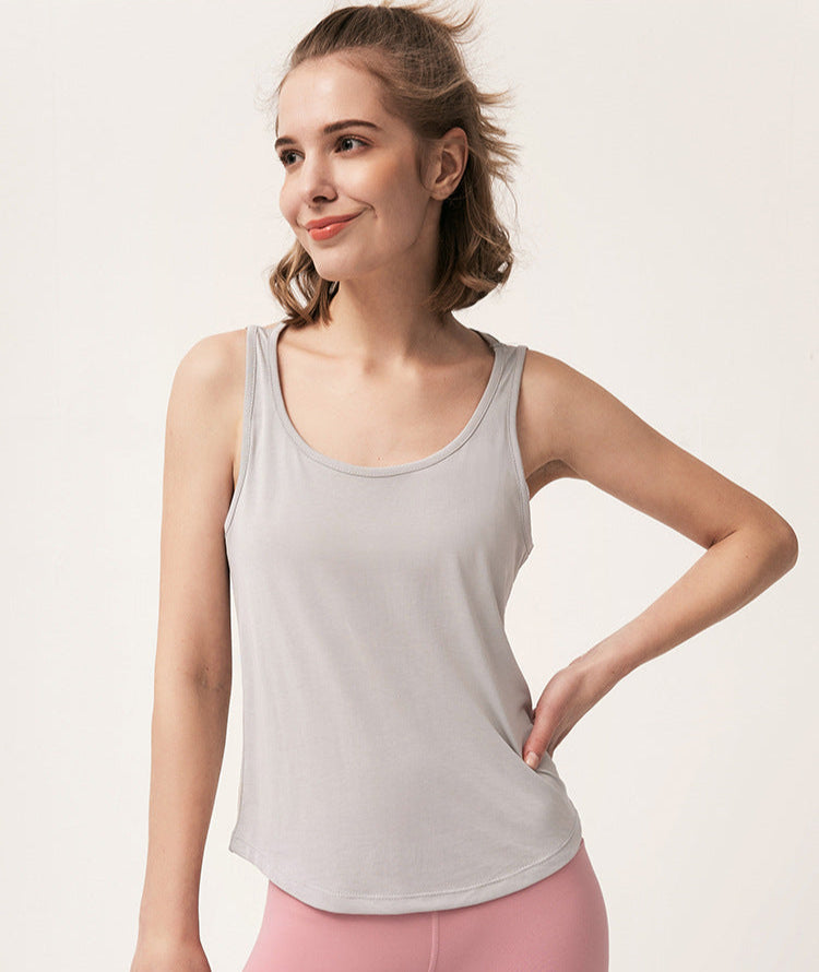Woman smiling in a light gray tank top and pink leggings with text overlay above.
