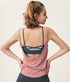 Back view of dusty pink tank top showing dark teal criss-cross sports bra.