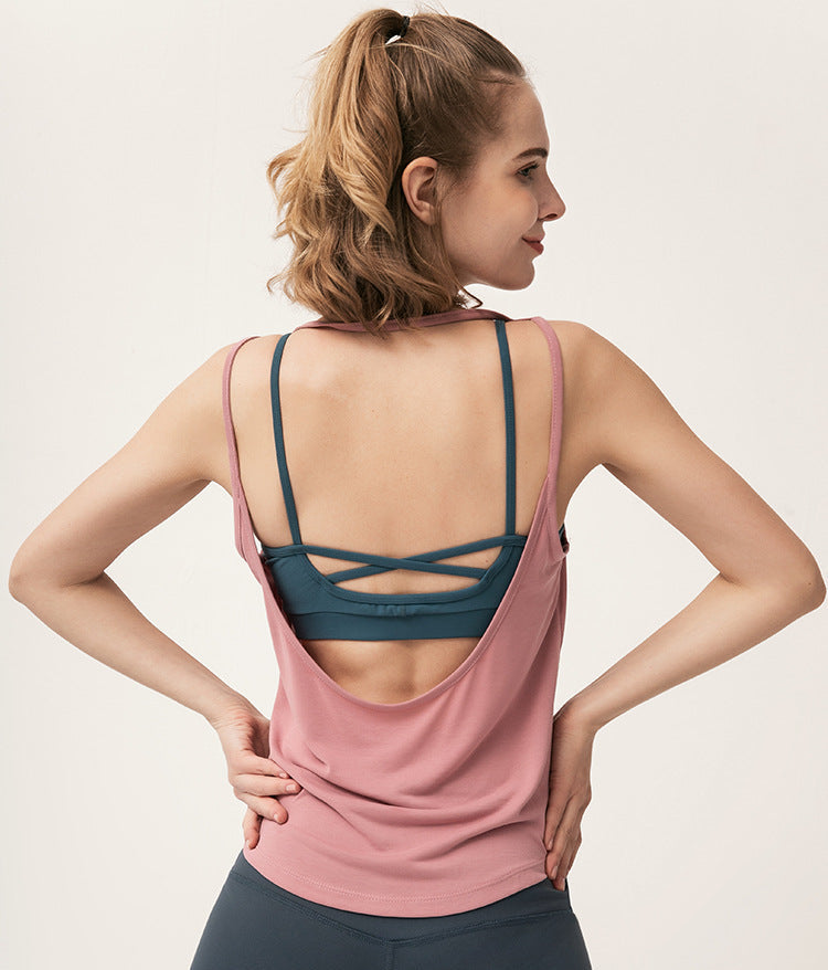 Back view of dusty pink tank top showing dark teal criss-cross sports bra.