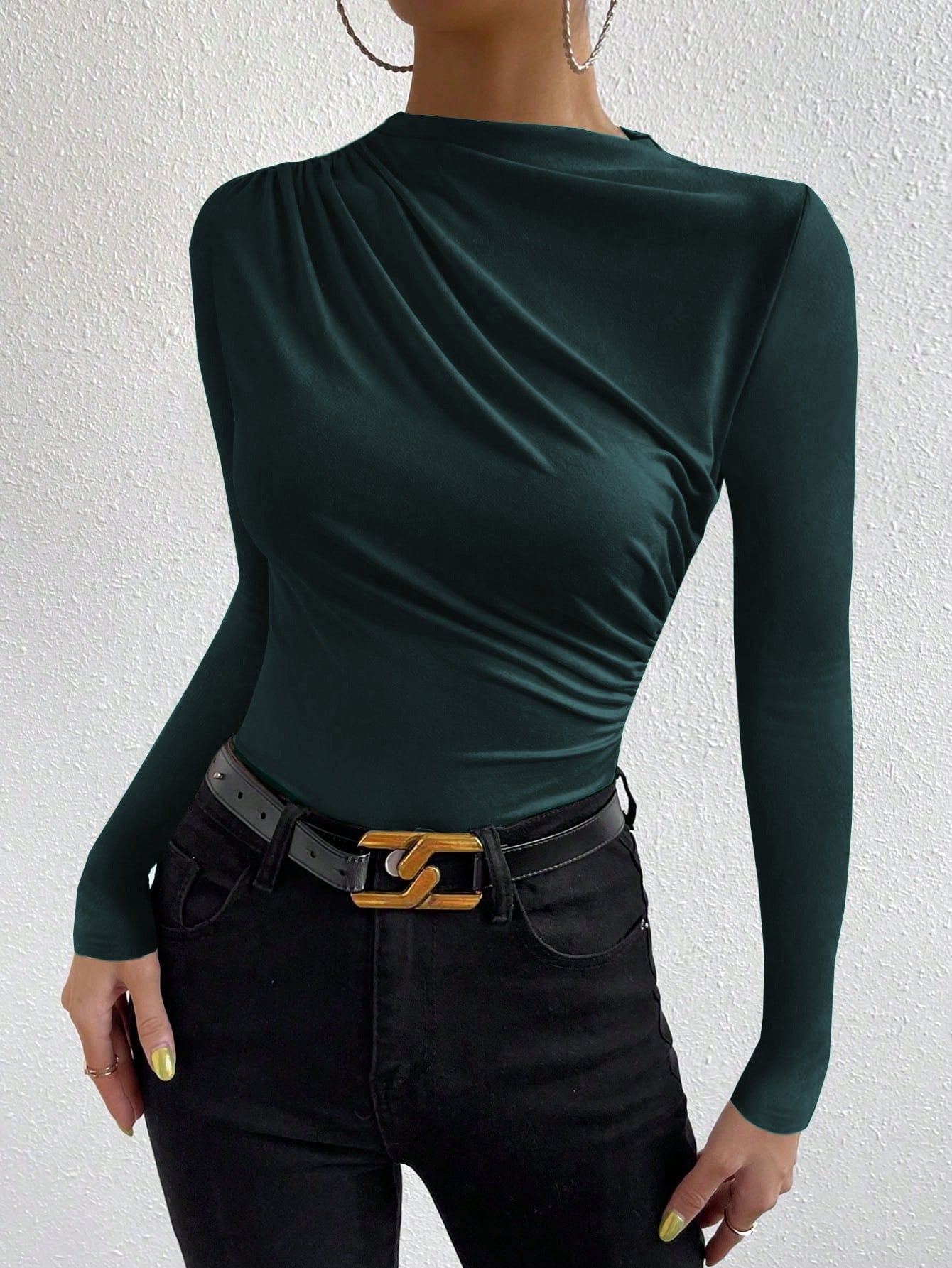 women’s slim fit ruched long sleeve top in green knit, draped crew neck, front three-quarter view with black jeans