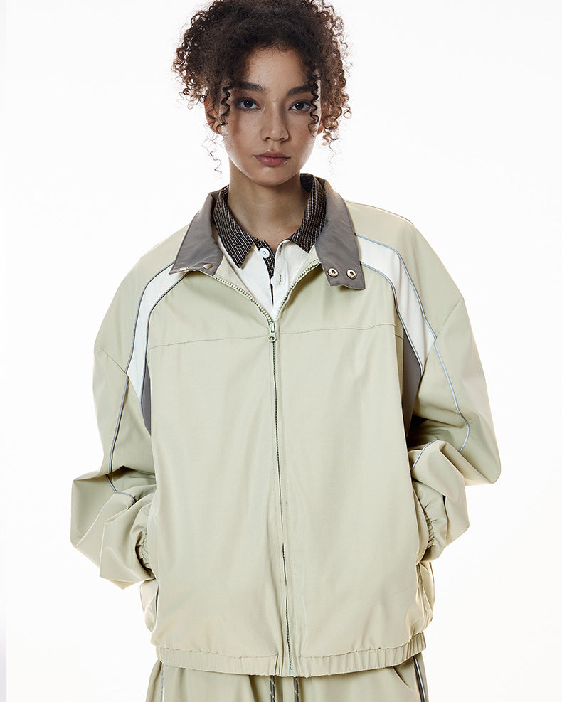 Light gray racing jacket zipped, relaxed stance, women’s wide leg pants