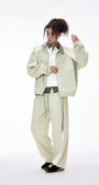 Light gray women’s tracksuit front view, racing jacket with women’s wide leg pants