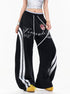Three-quarter view of female model styled in black side stripe curved leg lounge pants with white drawstring.