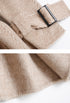 Belt knot and sleeve detail of beige wool coat