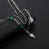 Close-up of silver double-chain necklace with green beads and dangling star charm.