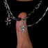 Star charm pendant resting on a finger, showing detailed shape and finish.