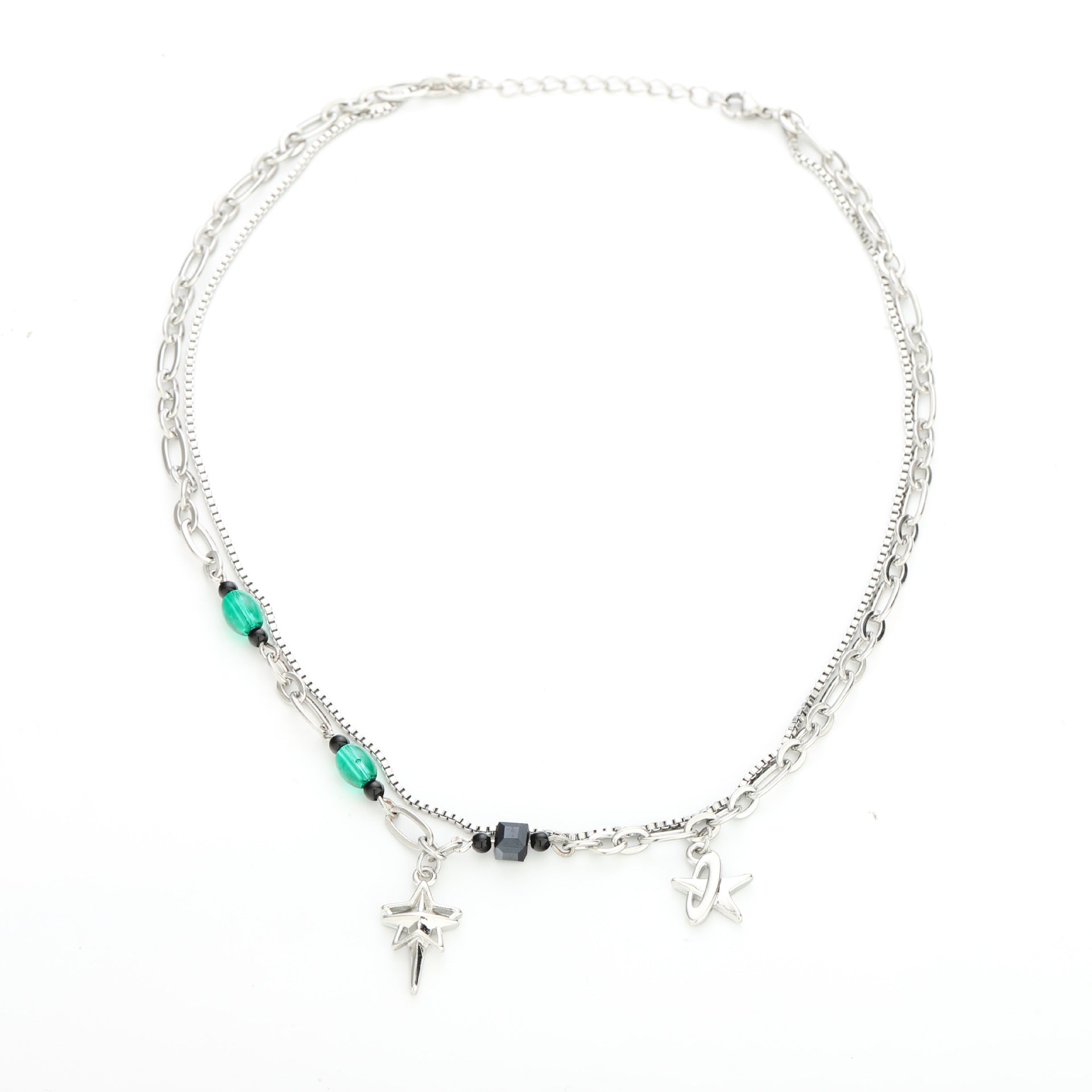 Full view of Y2K-style layered necklace with star and letter charms on white background.