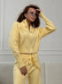 Woman styling yellow knit 2 piece set with zip jacket and pants