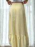 Back view of yellow flowy midi skirt with ruched hemline