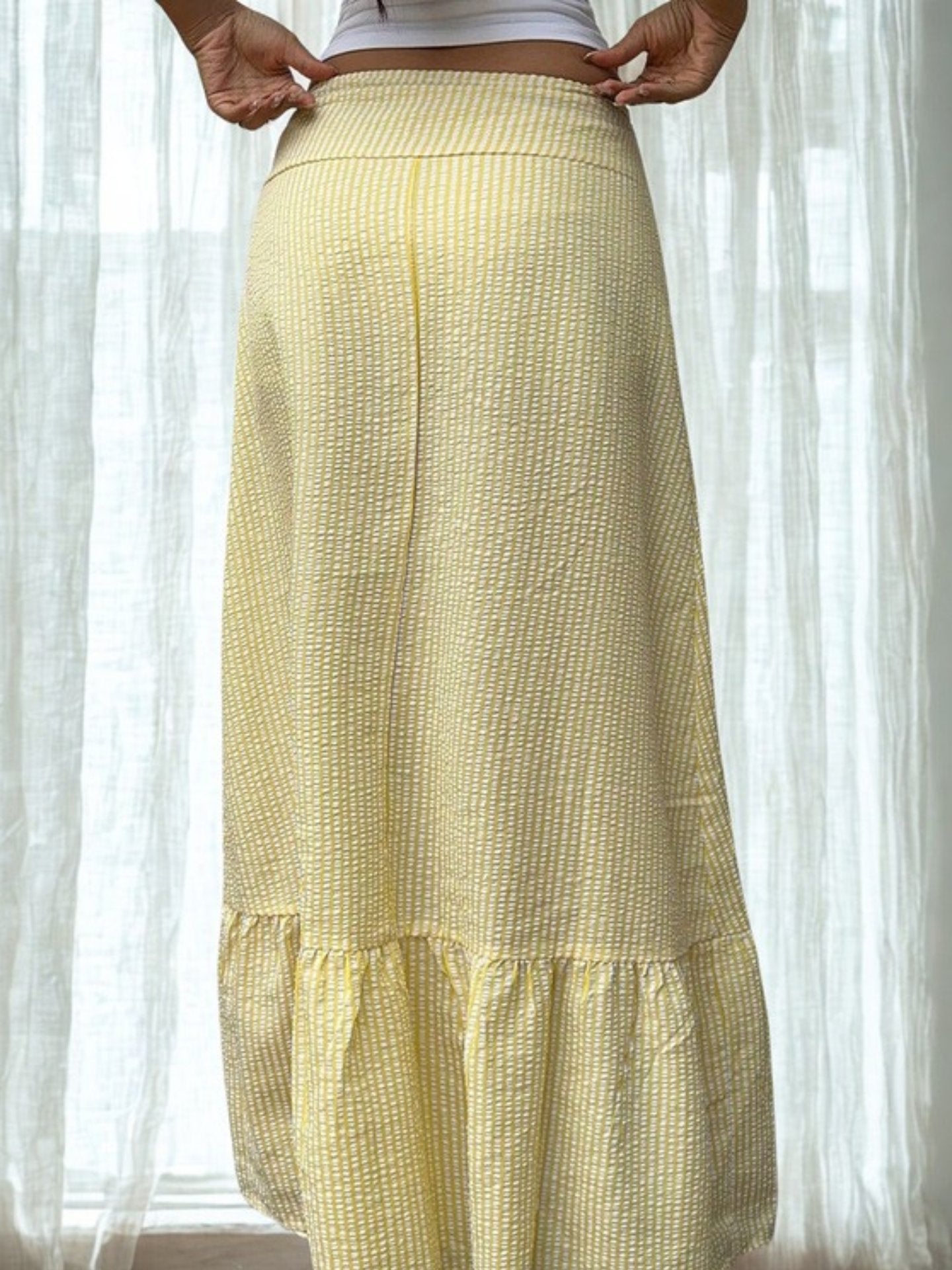 Back view of yellow flowy midi skirt with ruched hemline