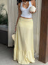 Side view of yellow summer midi skirt styled with halter top and accessories