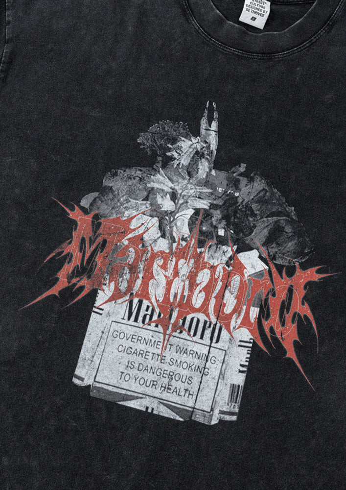 Close-up of print details on black Yesskary tee showing red gothic text and warning label.