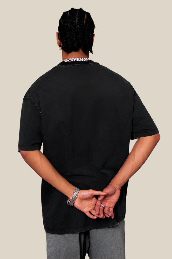 Back view of black Yesskary tee worn by male model.