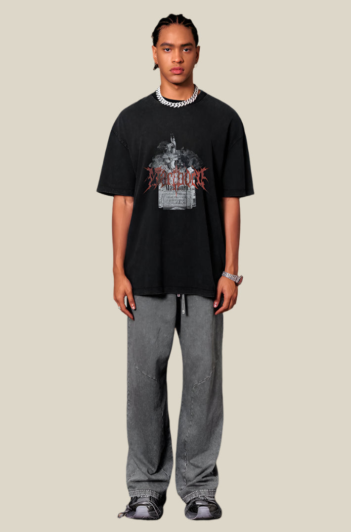 Male model wears black Yesskary tee with gray pants and chain necklace.
