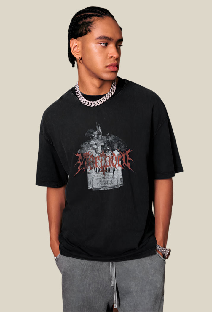 Male model in black Yesskary tee looks to the side with hands in pockets.