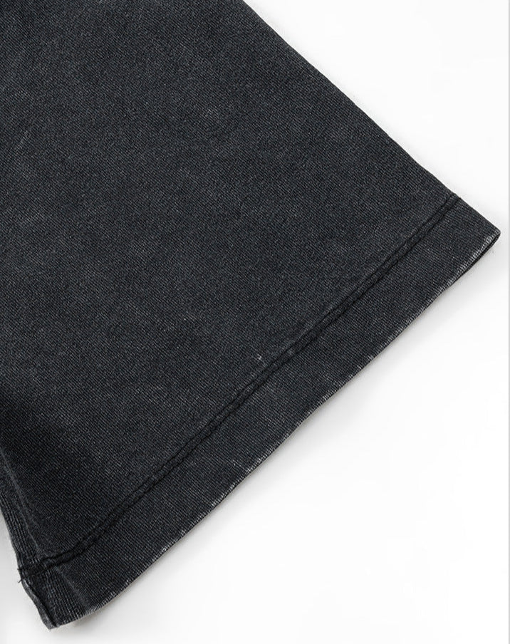 Detailed view of sleeve hem on black Yesskary tee.