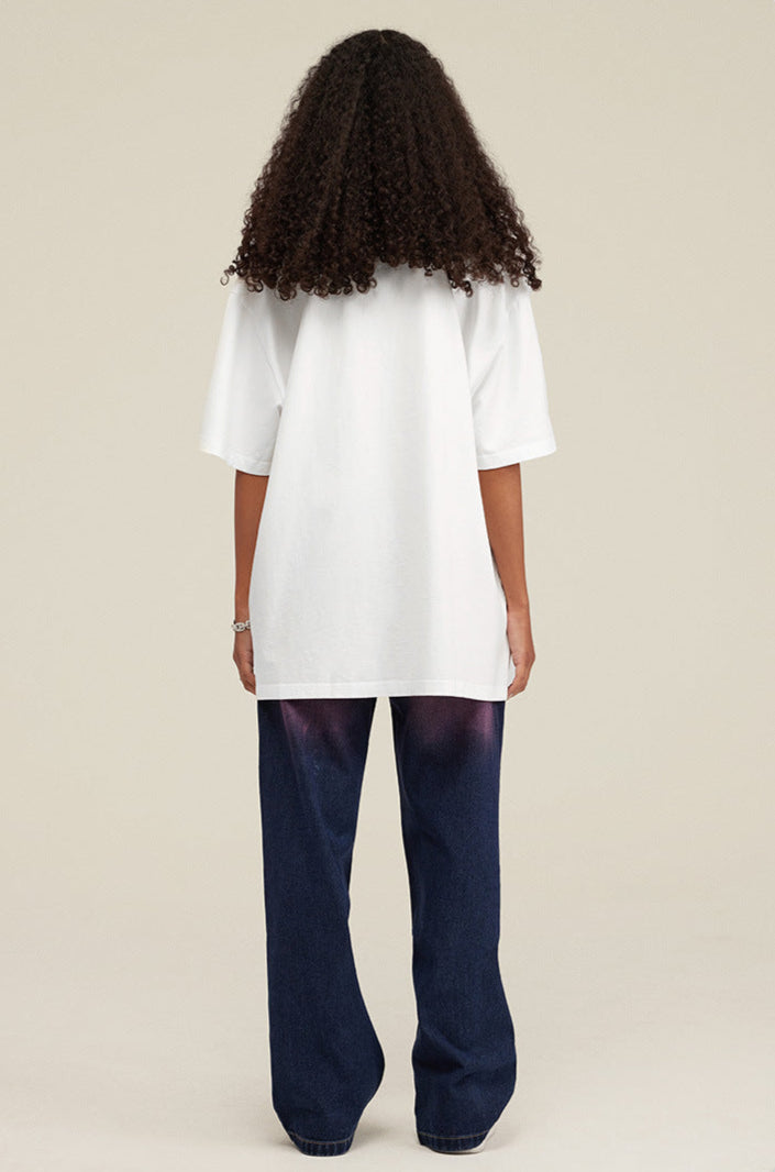 Back view of female model wearing white Yesskary tee.