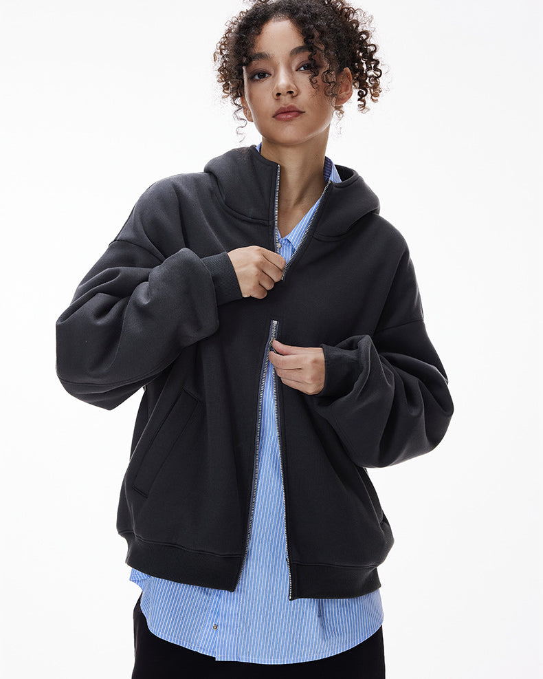 Navy blue hoodie showing two-way zipper being adjusted