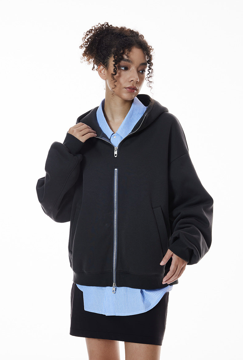 Navy blue zip hoodie on female model half-zip layered over shirt