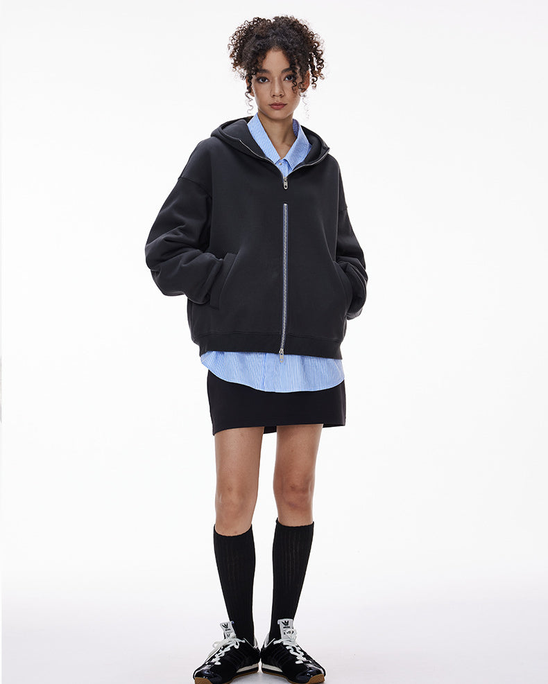 Navy blue zip hoodie on female model front view, oversized fit